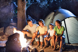 A family sitting around a campfire